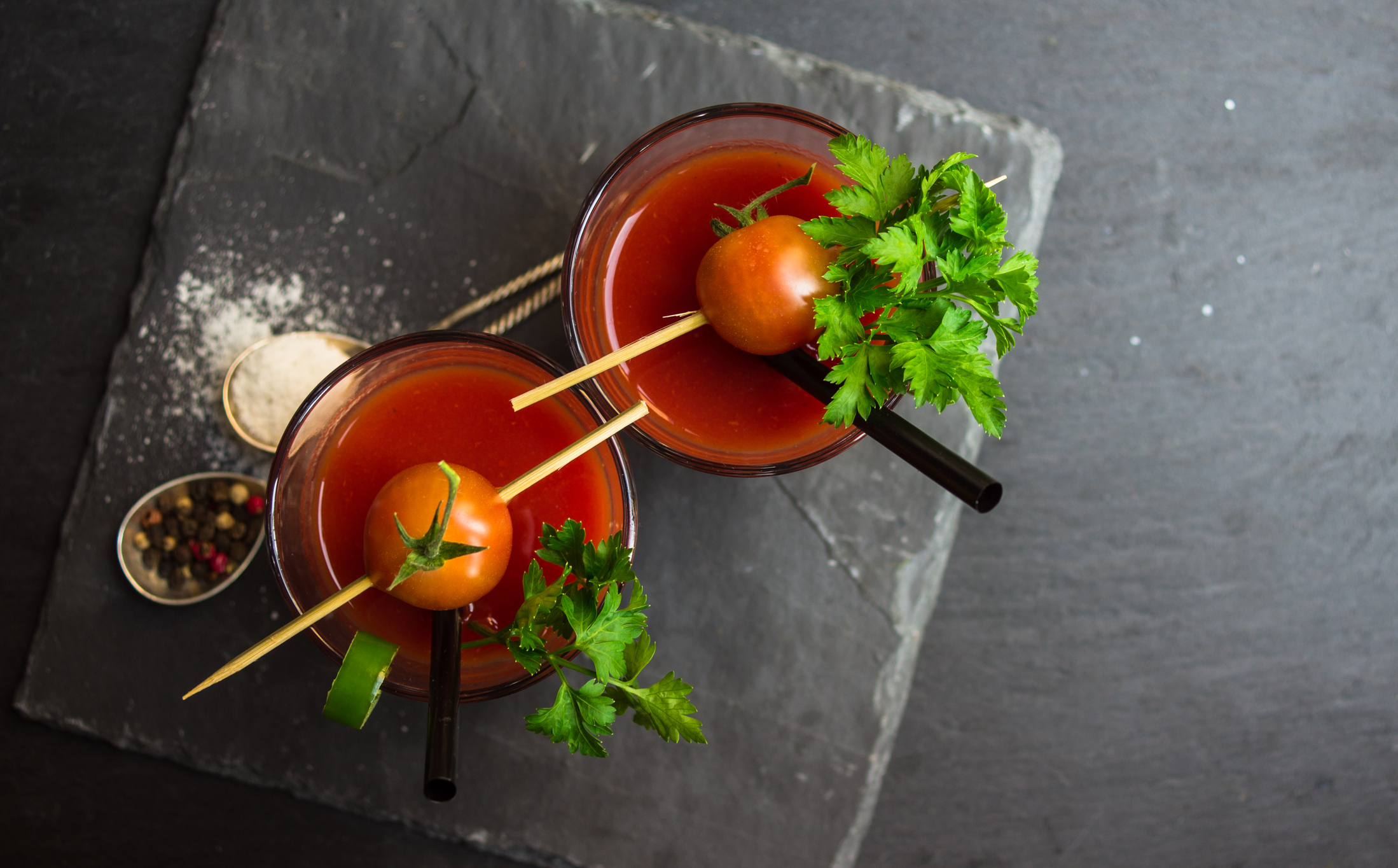 Fresh tomato juice with cherry tomatoes and chili pepper on rustic background