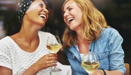 Two friends enjoying white wine