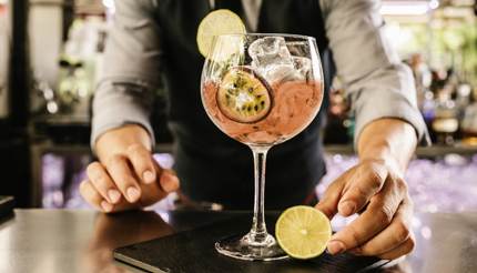 A bartender serving a cocktail