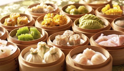 An assortment of dim sum in bamboo steamers