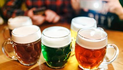 Five authentic crafted mugs of Czech beer in a Prague pub