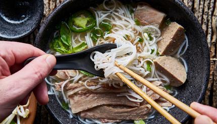 Eating pho with chopsticks and a spoon