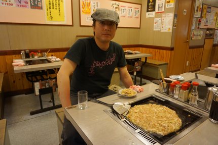 Man eating Monjayaki in Tsukishima