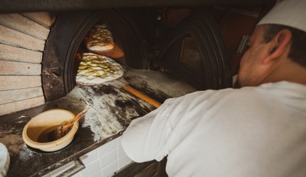 A baker making schiacciata, a type of flatbread