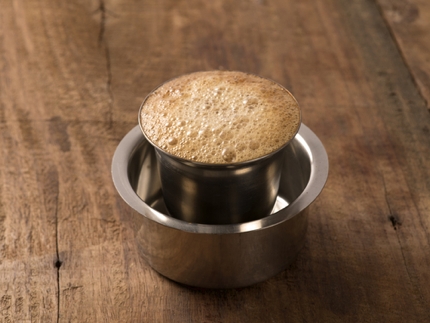 Kaapi is served in a metal cup nested within a 'dabarah' saucer