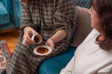 Having one's fortune told from the leftover coffee grounds