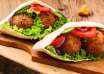 Falafel in pita bread with tomatoes, cucumber, lettuce and red onions
