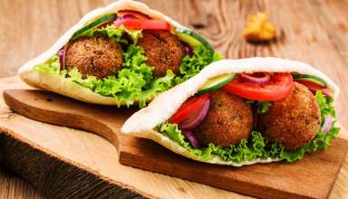 Falafel in pita bread with tomatoes, cucumber, lettuce and red onions
