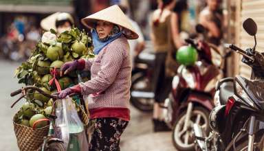 Vietnamese woman sells cocoes on the street