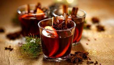 Glasses of mulled wine with orange slices and cinnamon sticks