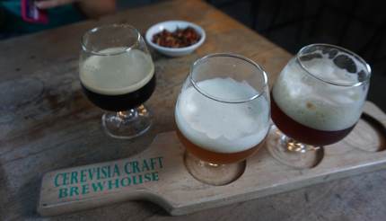 Glasses of beer on a wooden board in Cerevisia Craft Brewhouse