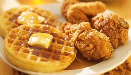 Chicken and waffles with syrup on the waffles