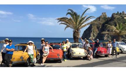 Tourists in front of Classic Convertible Fiat 500s