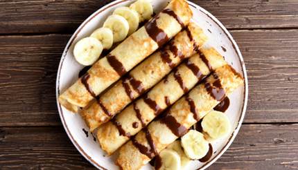 Crêpes with chocolate sauce and banana slices