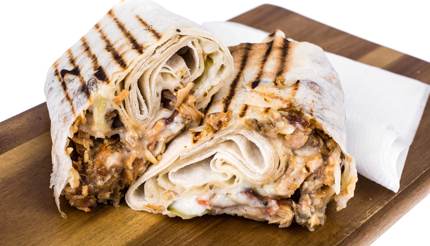 Shawarma on wooden chopping board