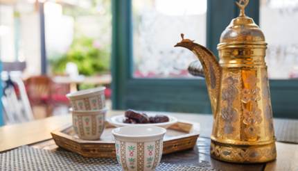 Arab coffee, dates in a bowl in the background