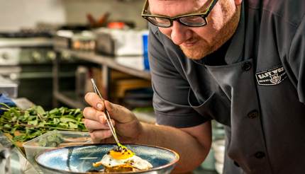 Matt Venzke, Executive Chef at East West Brewing Co. preparing food