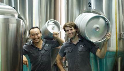 Sean Trung with co-worker holding beer kegs