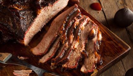 Beef brisket - sliced on wooden board